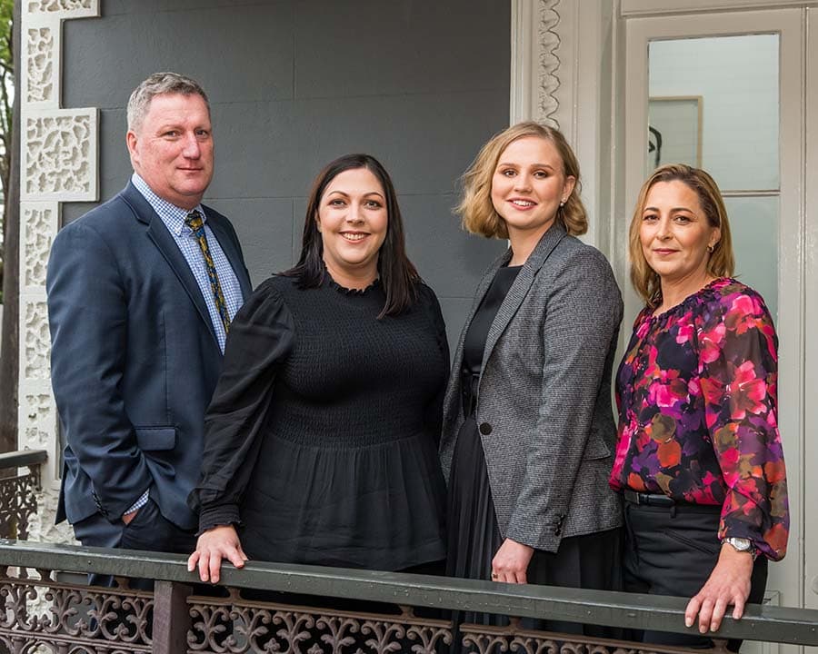 Skuse Graham Criminal Lawyer team photo on balcony.