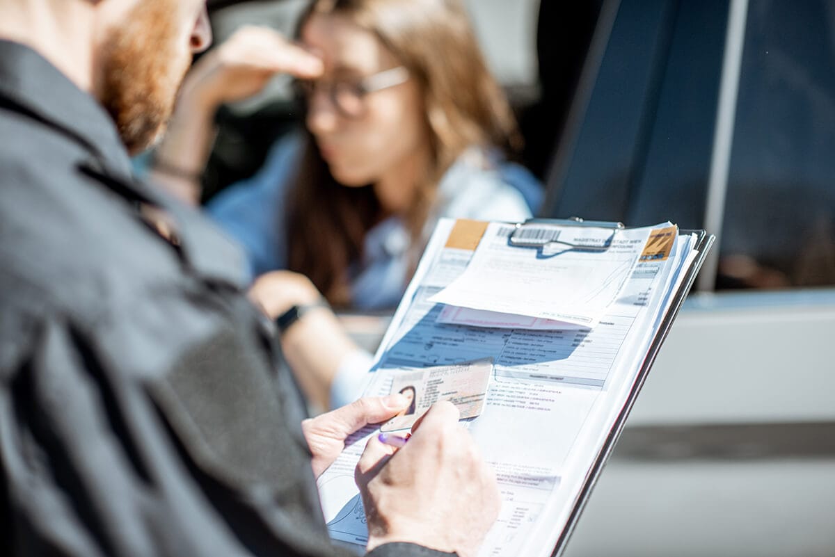 Young lady receiving traffic ticket.