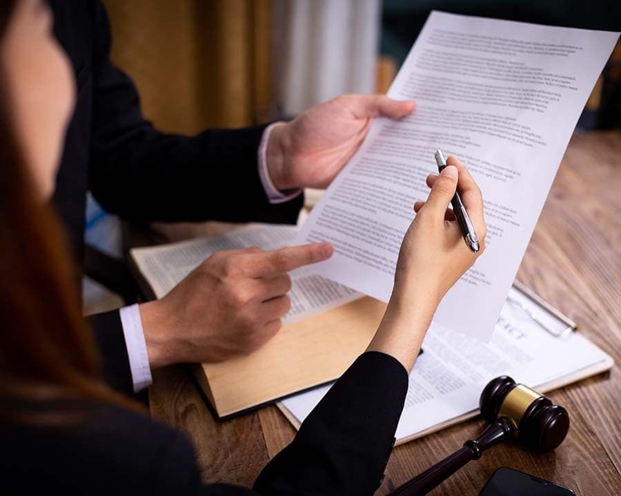 Lawyer and client going through legal agreement.